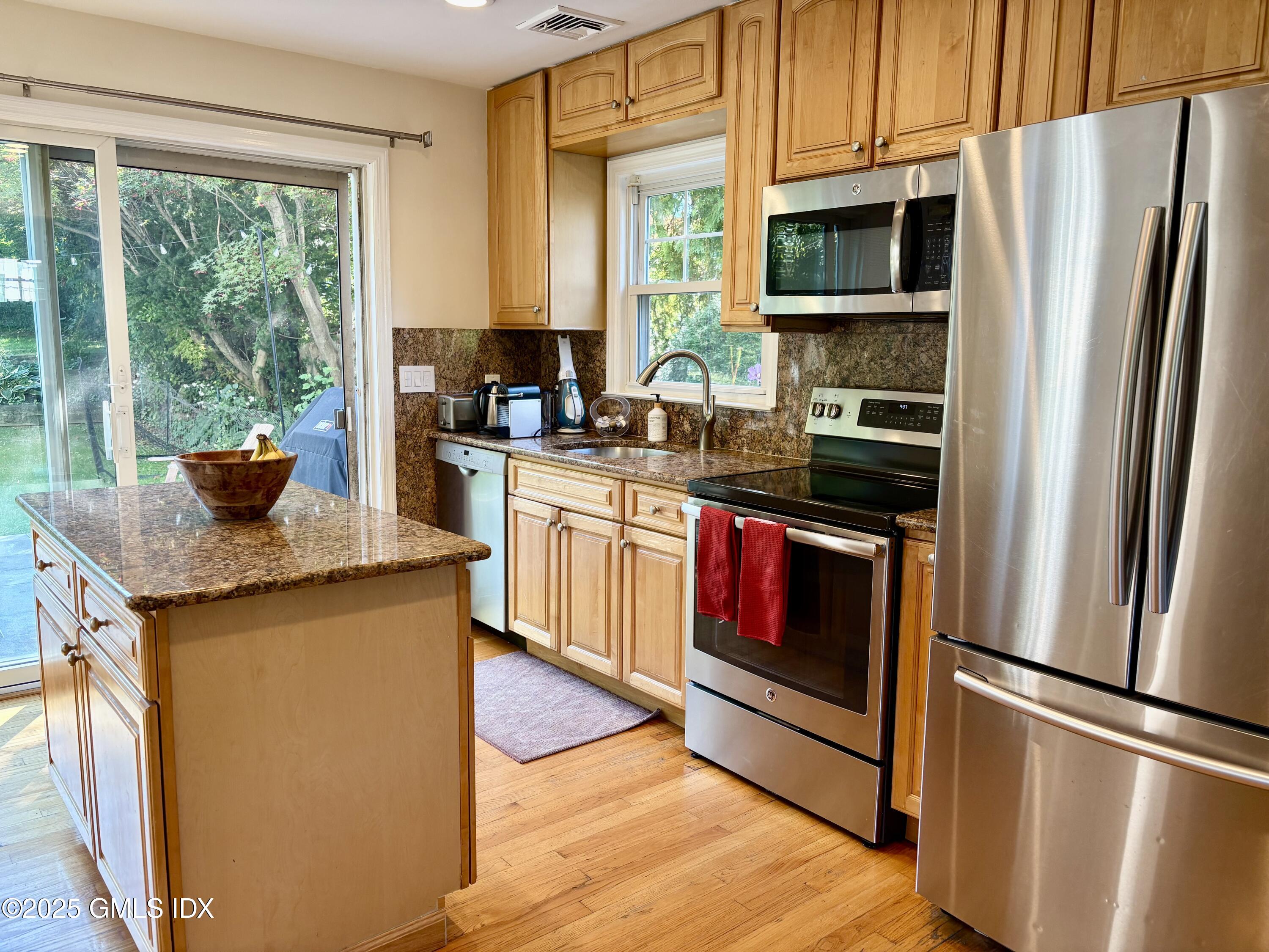 19 Wescott Street Riverside, CT 06878 - Photo 6 of 21 a kitchen with stainless steel appliances granite countertop a refrigerator a stove a sink and a microwave