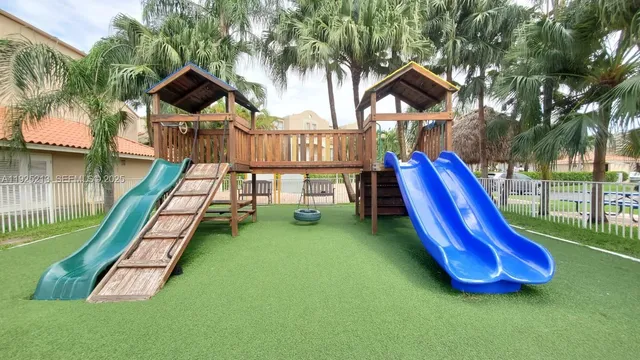 a view of a park with swings and slides