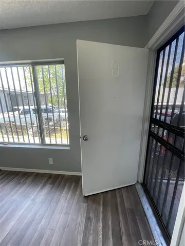 a view of a room with wooden floor