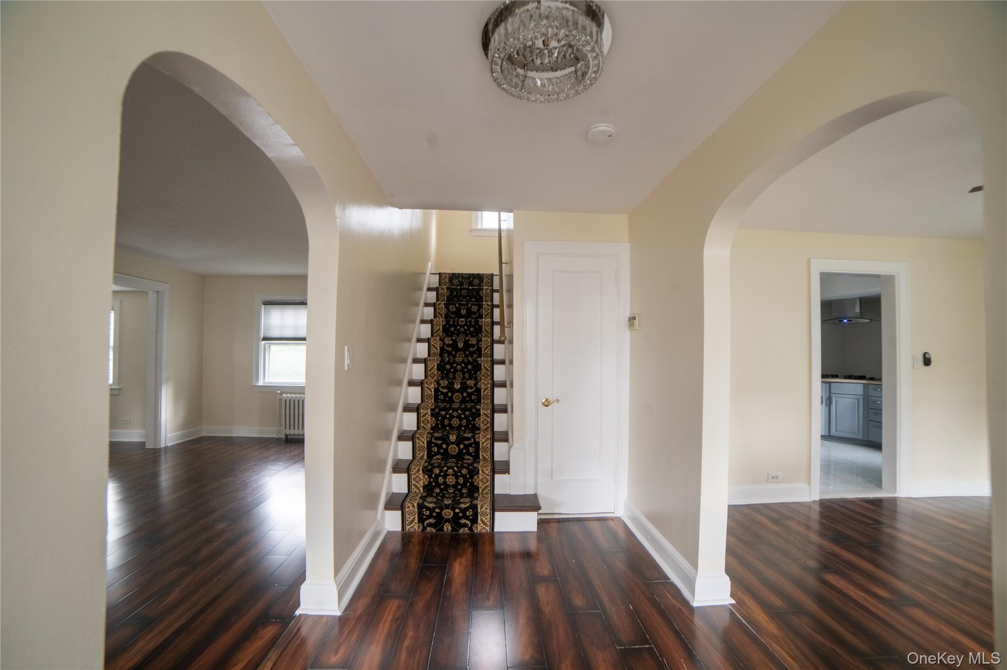 Entrance foyer showing beautiful floors to living room, dining room and stairs to the bedrooms floor.