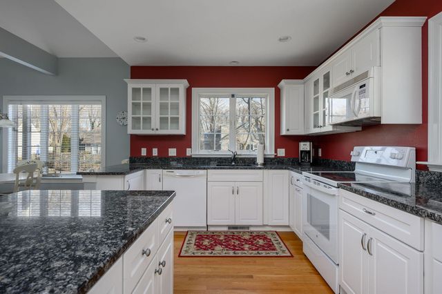 a kitchen with stainless steel appliances granite countertop a stove a sink and a granite counter tops