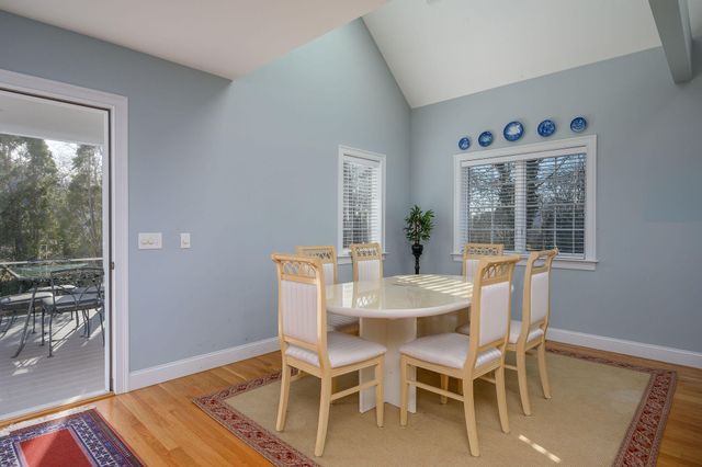 a dining room with furniture and wooden floor