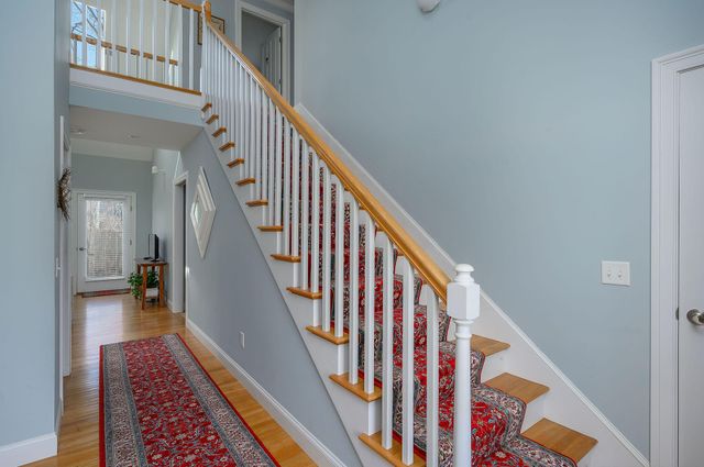a bedroom with a bed chair and windows