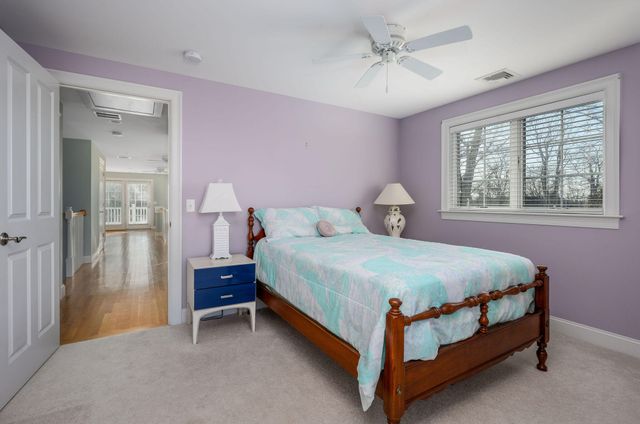 a view of a brick house with iron fence