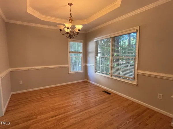 a view of livingroom with window wooden floor and chandelier