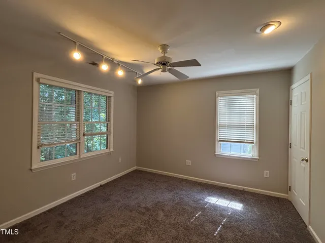 a view of a livingroom with a ceiling fan and window