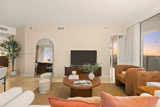a living room with furniture and a large mirror
