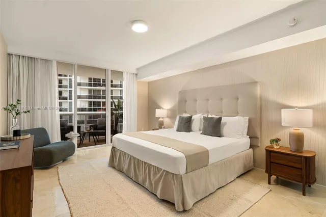 a bedroom with a large bed and a book shelf