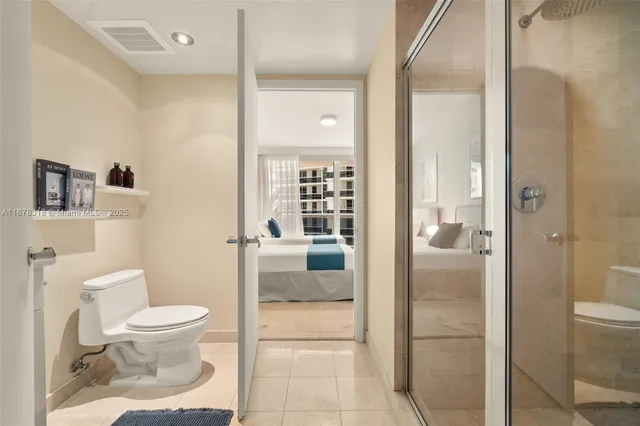 a bathroom with a toilet and a shower