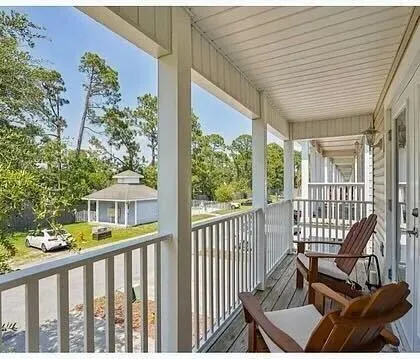 a view of a balcony with chairs