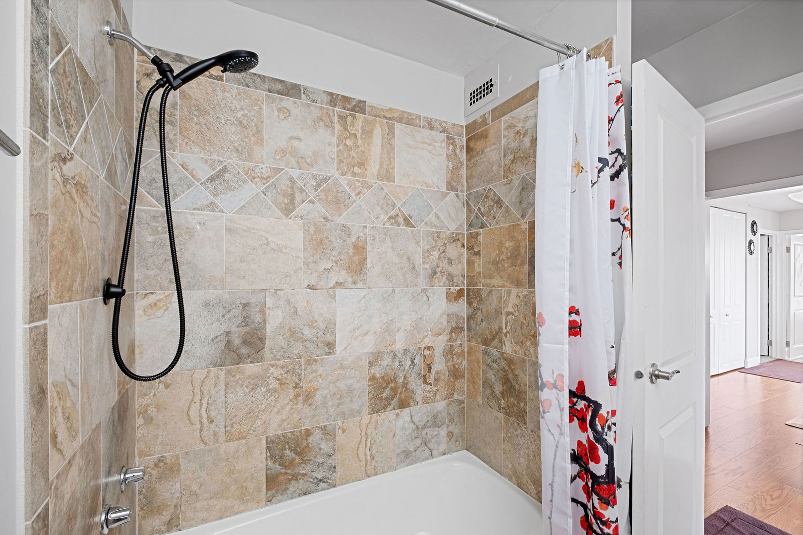 5445 North Sheridan Road, Unit 802 Chicago, IL 60640 - Photo 18 of 32 a bathroom with a shower and a shower curtain