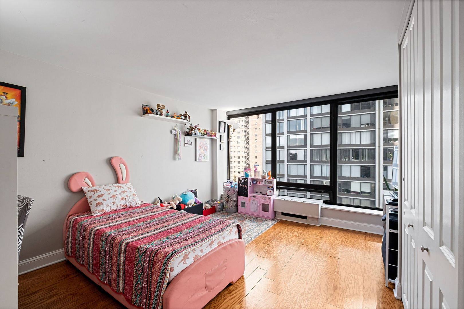 5445 North Sheridan Road, Unit 802 Chicago, IL 60640 - Photo 19 of 32 a bedroom with bed and a large window with outer view