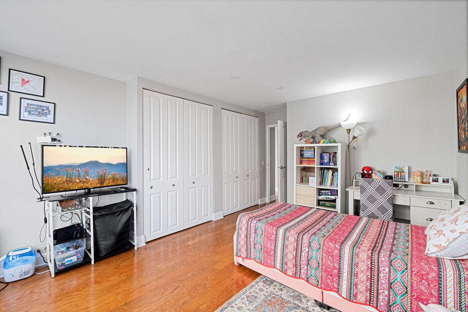 5445 North Sheridan Road, Unit 802 Chicago, IL 60640 - Photo 21 of 32 a bedroom with a bed and a flat screen tv