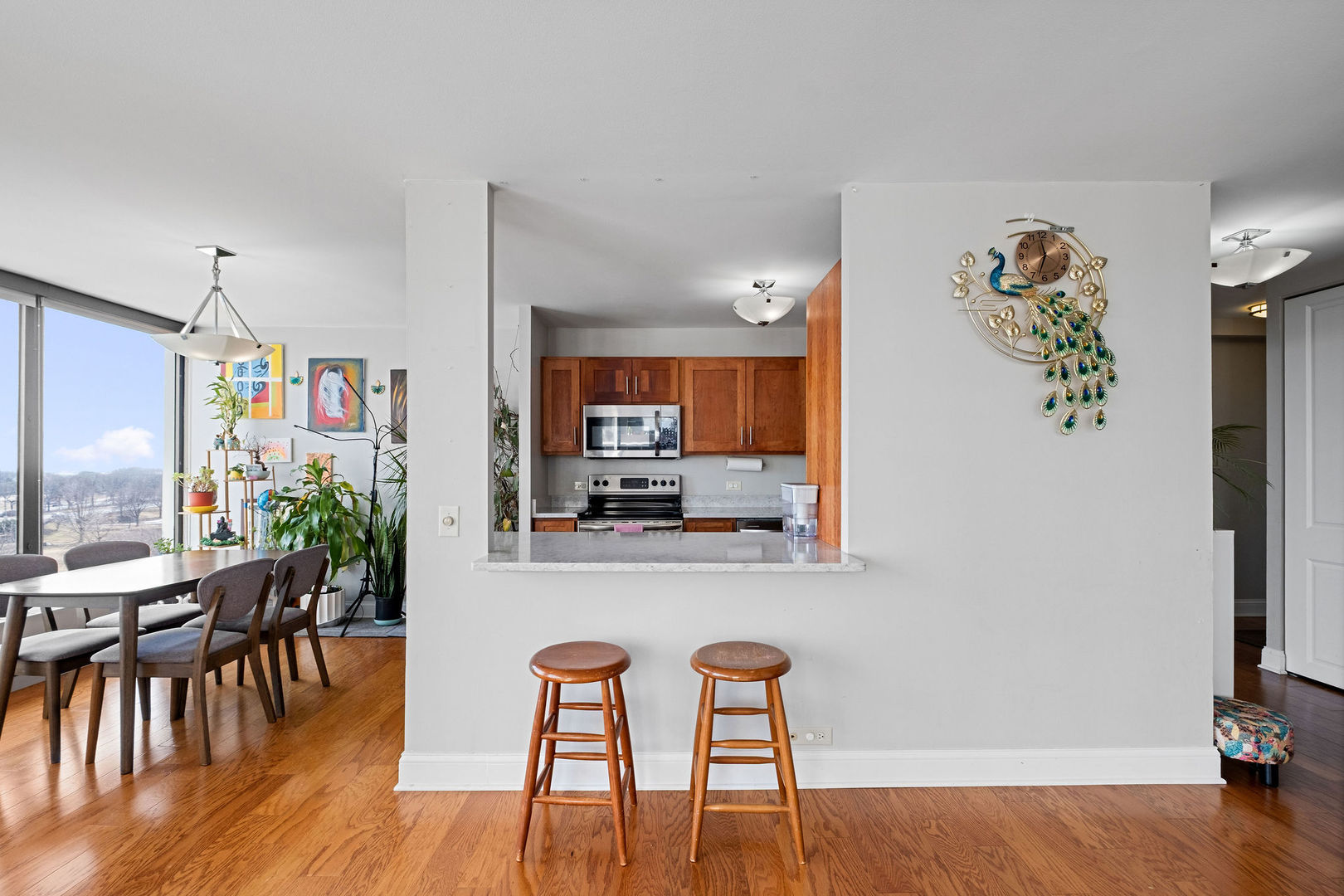 5445 North Sheridan Road, Unit 802 Chicago, IL 60640 - Photo 7 of 32 a view of a dining room with furniture and wooden floor