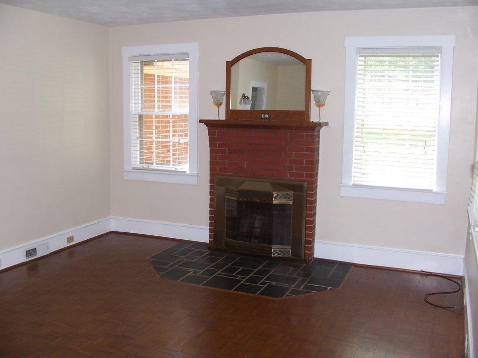 1065 Gross Hollow Road Blue Ridge, VA 24064 - Photo 2 of 8 an empty room with windows fireplace and wooden floor
