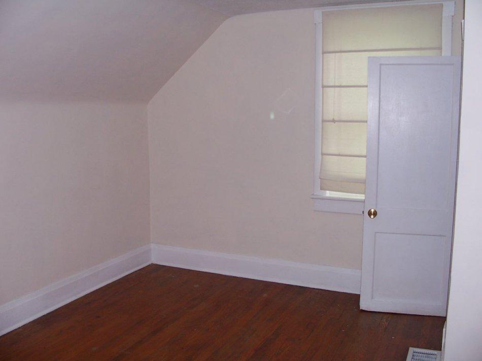 1065 Gross Hollow Road Blue Ridge, VA 24064 - Photo 6 of 8 an empty room with wooden floor and white walls