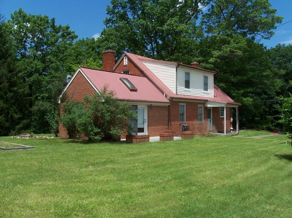 1065 Gross Hollow Road Blue Ridge, VA 24064 - Photo 8 of 8 a front view of a house with a garden