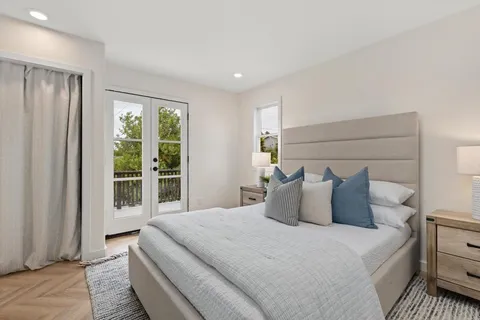 a bedroom with a large bed and a large window