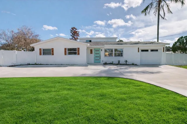 a backyard of a house with table and chairs