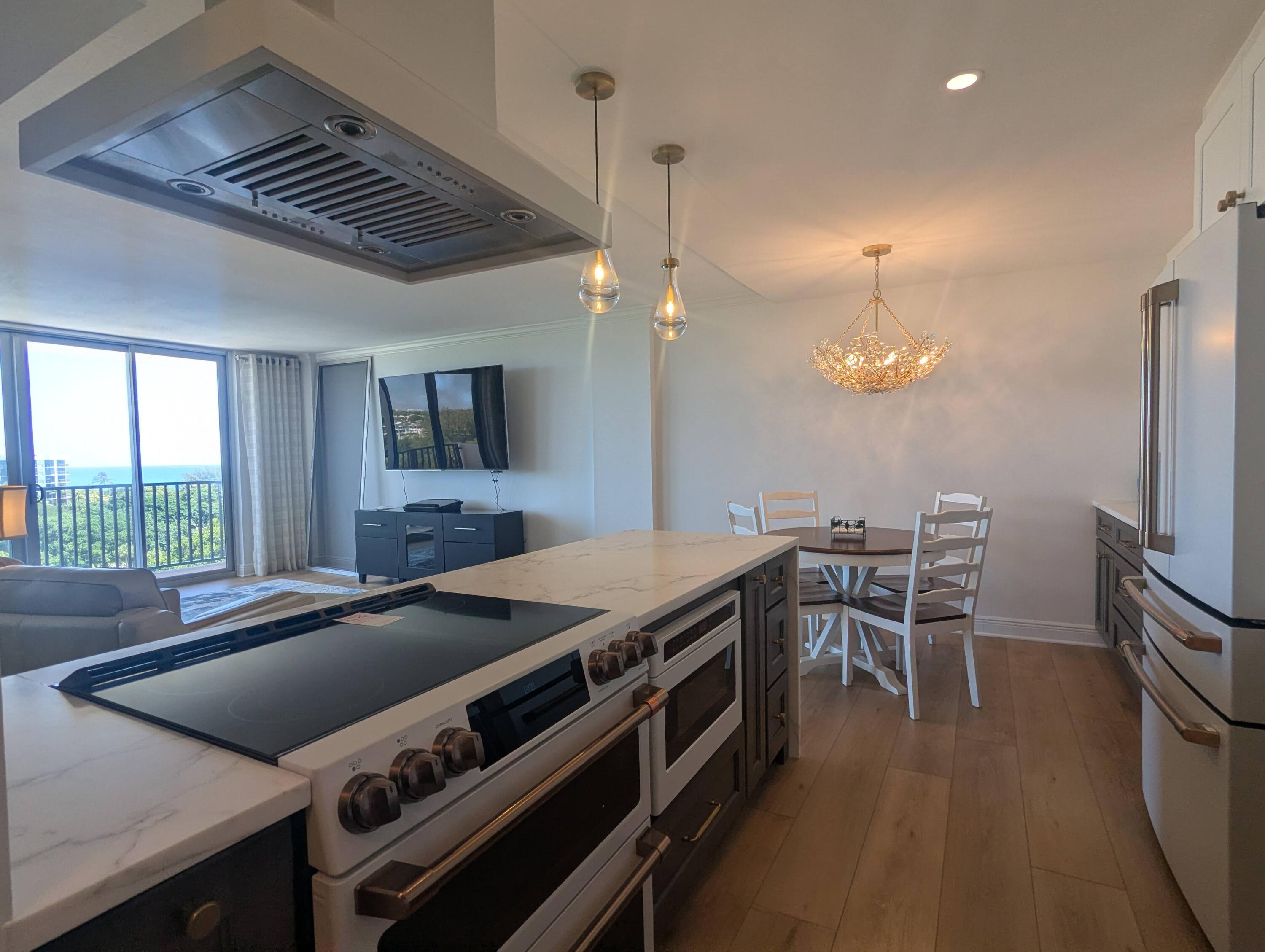 2121 North Ocean Boulevard, Unit 1006E Boca Raton, FL 33431 - Photo 7 of 64 a kitchen with a stove and a wooden floors
