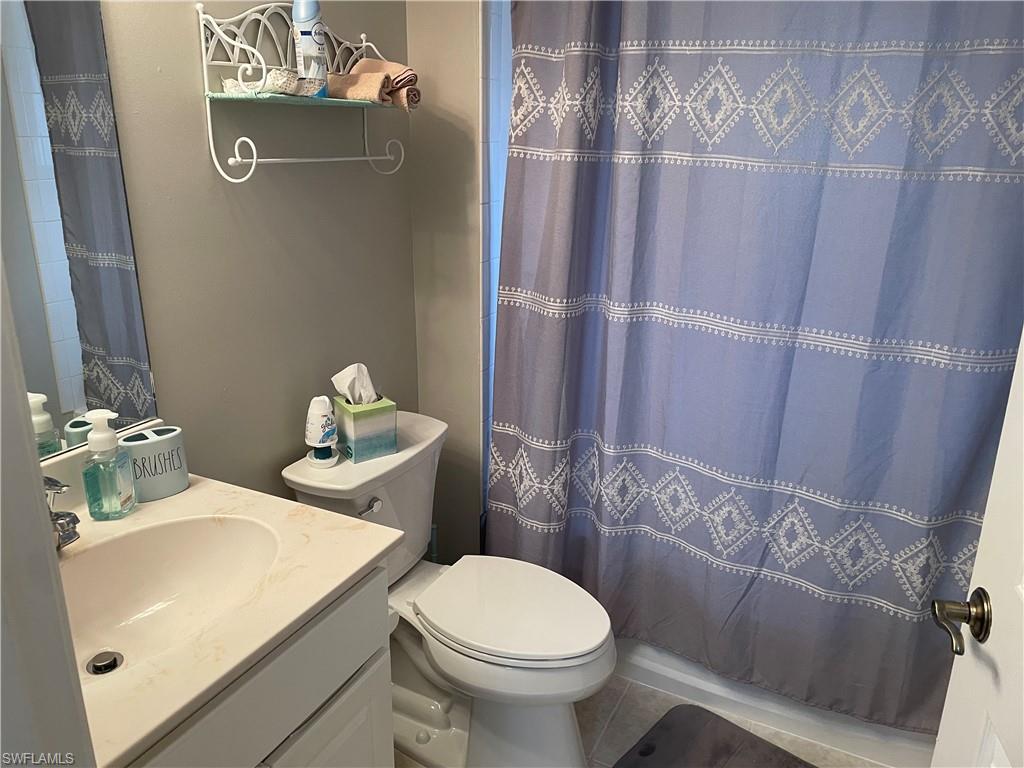 9195 Michael Circle, Unit 1301 Naples, FL 34113 - Photo 13 of 25 a bathroom with a sink and toilet