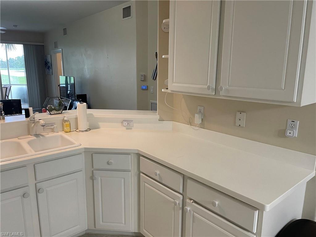 9195 Michael Circle, Unit 1301 Naples, FL 34113 - Photo 16 of 25 a room with cabinets and white appliances