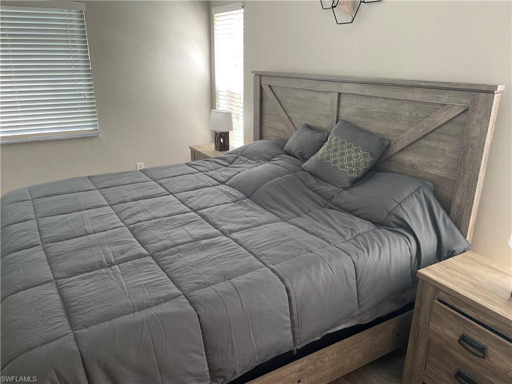 9195 Michael Circle, Unit 1301 Naples, FL 34113 - Photo 20 of 25 a bedroom with a bed and window