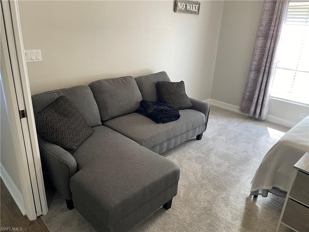 9195 Michael Circle, Unit 1301 Naples, FL 34113 - Photo 22 of 25 a living room with furniture and a window