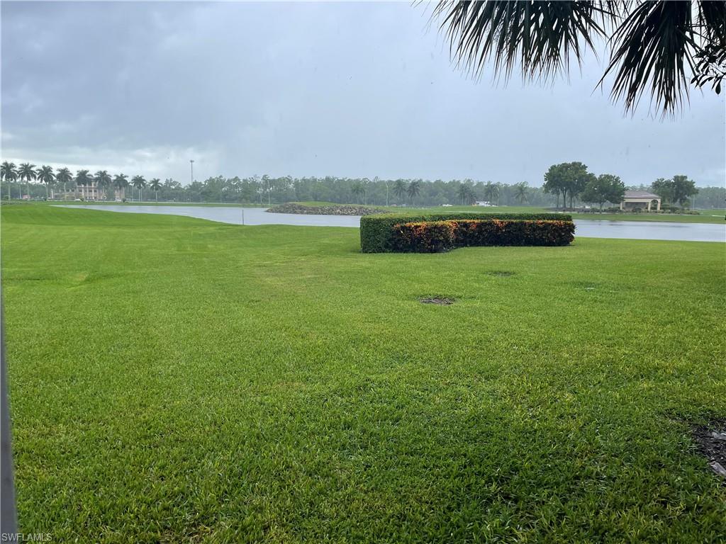 9195 Michael Circle, Unit 1301 Naples, FL 34113 - Photo 4 of 25 a view of a lake with houses in the back