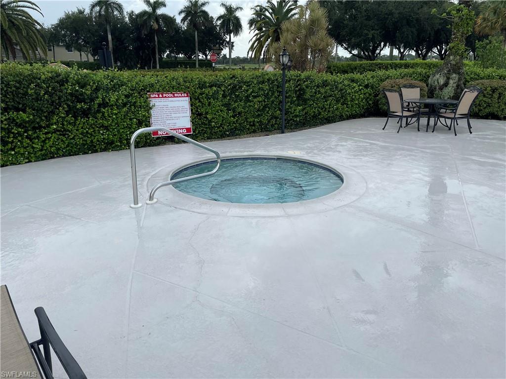 9195 Michael Circle, Unit 1301 Naples, FL 34113 - Photo 5 of 25 a view of a table and chairs in the garden