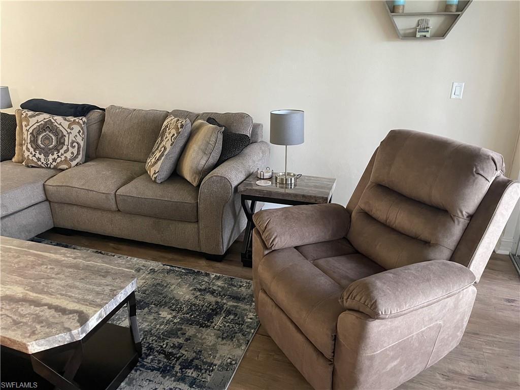 9195 Michael Circle, Unit 1301 Naples, FL 34113 - Photo 8 of 25 a living room with furniture and a couch