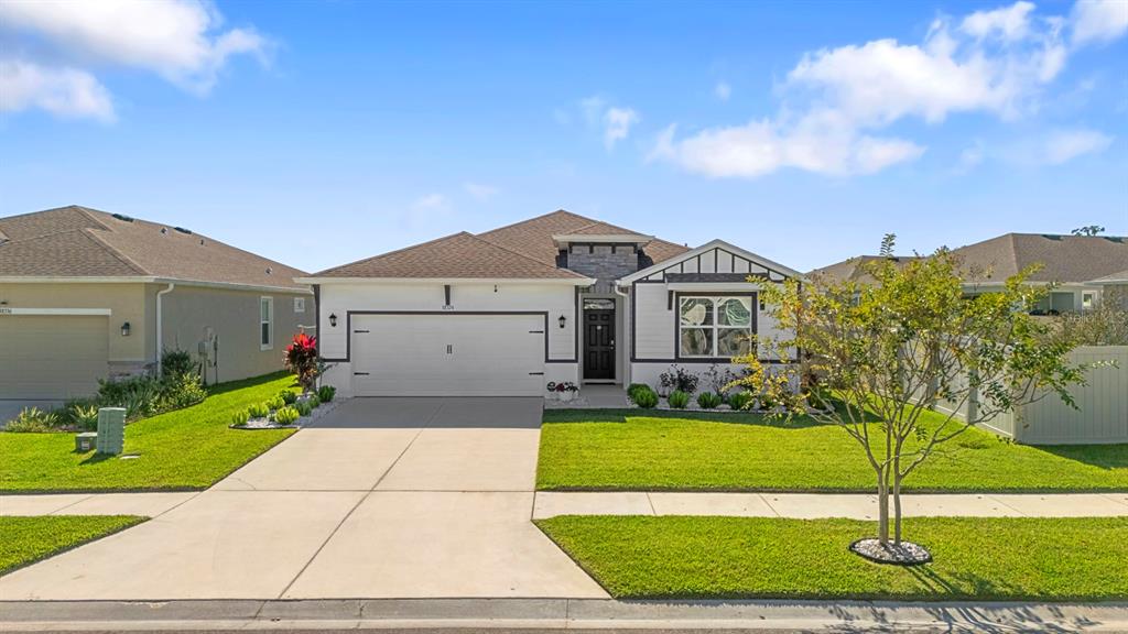 a front view of a house with a yard and garage