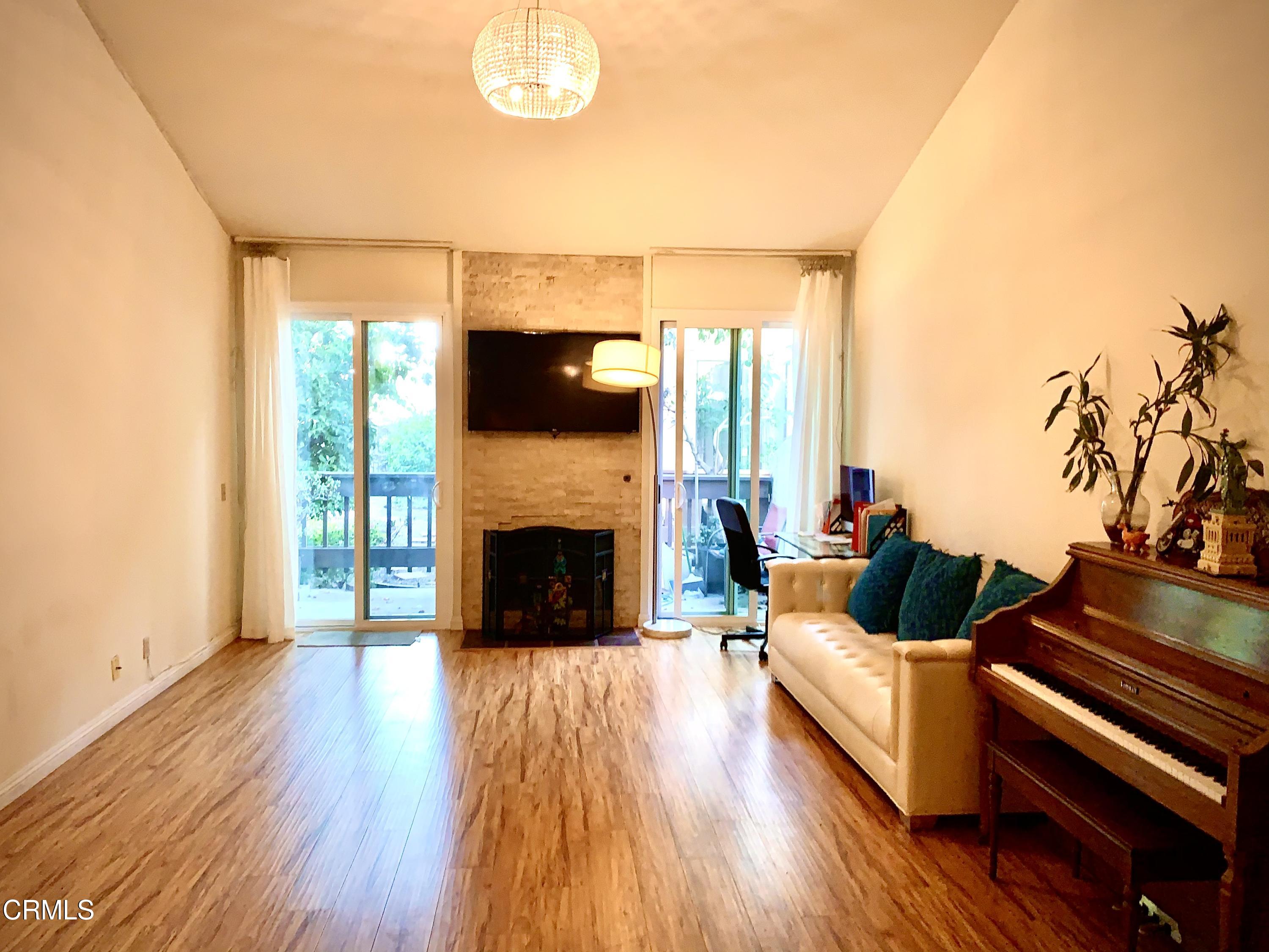 3232 La Vina Way Pasadena, CA 91107 - Photo 12 of 27 a living room with furniture fireplace and a flat screen tv