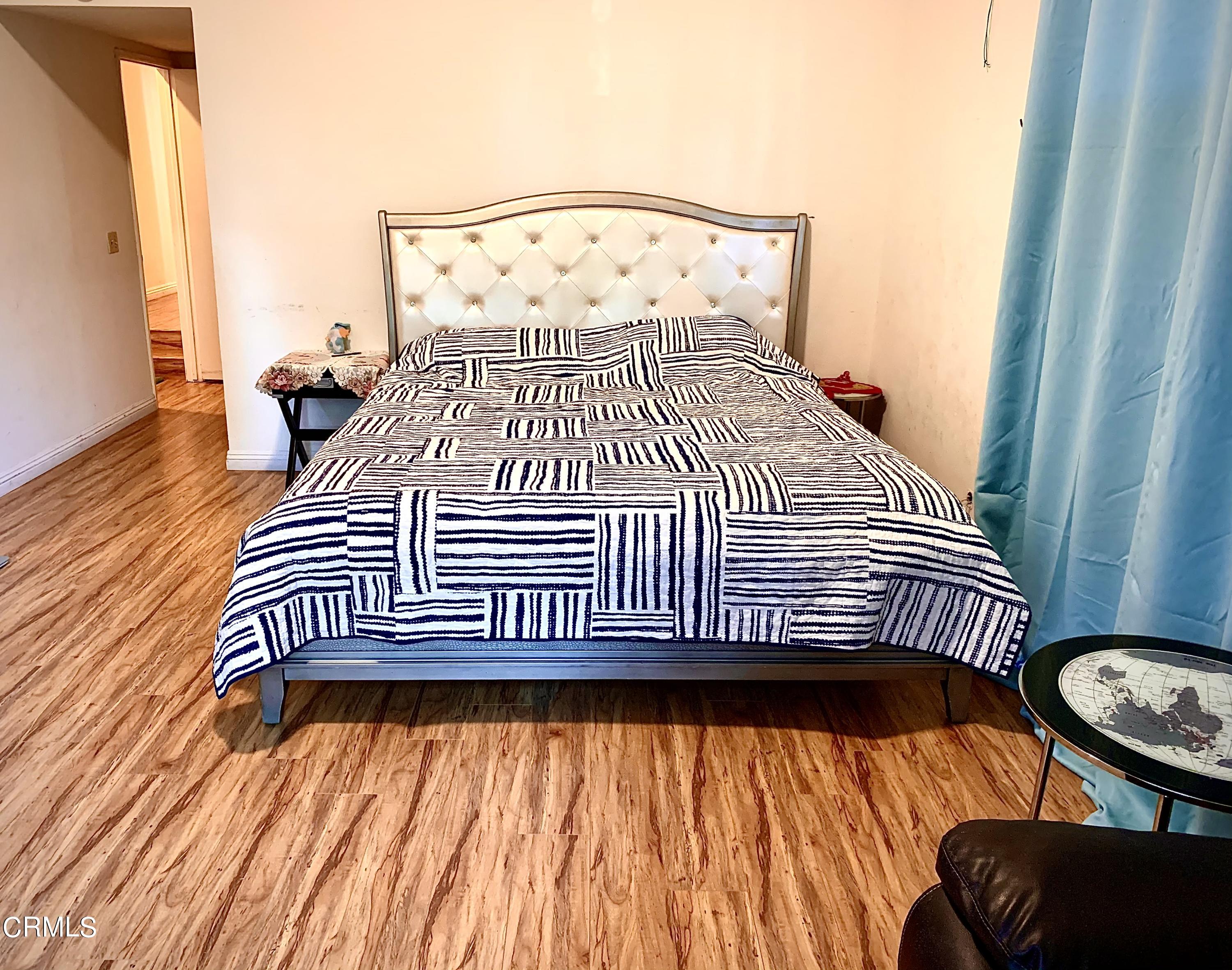 3232 La Vina Way Pasadena, CA 91107 - Photo 15 of 27 a bedroom with a bed and wooden floor