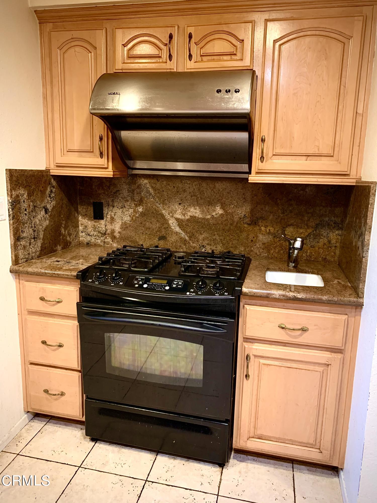 3232 La Vina Way Pasadena, CA 91107 - Photo 9 of 27 a stove top oven sitting inside of a kitchen
