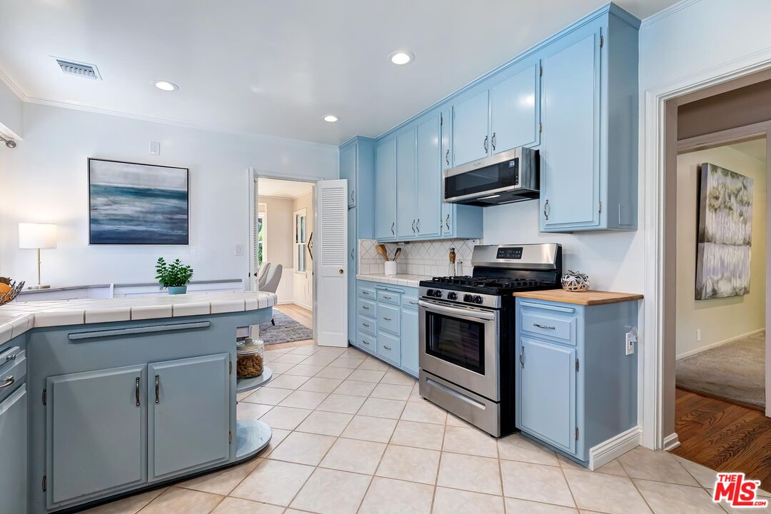 929 Mesa Verde Road Pasadena, CA 91105 - Photo 15 of 51 a kitchen with cabinets stainless steel appliances and a counter space