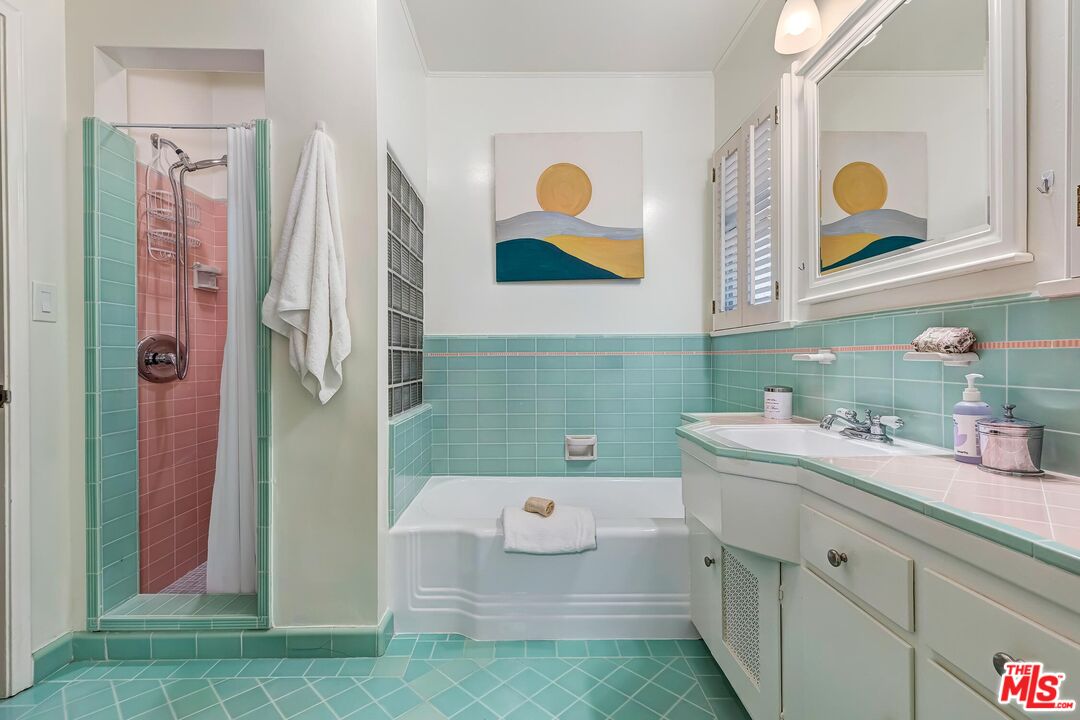 929 Mesa Verde Road Pasadena, CA 91105 - Photo 24 of 51 a bathroom with a sink a mirror and a shower curtain
