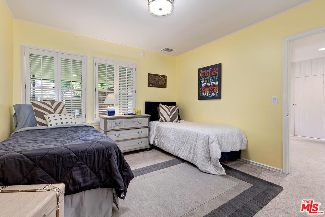 929 Mesa Verde Road Pasadena, CA 91105 - Photo 25 of 51 a bedroom with a bed and wooden floor