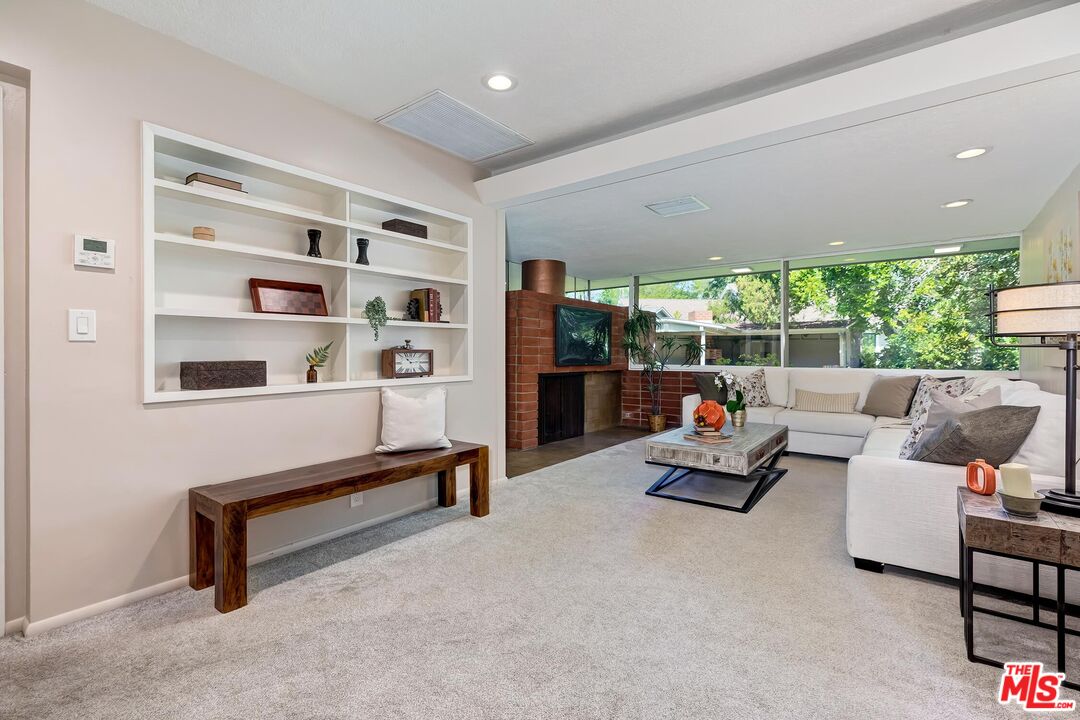 929 Mesa Verde Road Pasadena, CA 91105 - Photo 28 of 51 a living room with furniture gym equipment and a large window