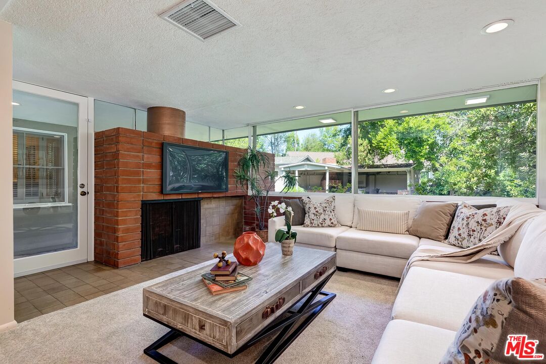 929 Mesa Verde Road Pasadena, CA 91105 - Photo 30 of 51 a living room with furniture coffee table and a fireplace