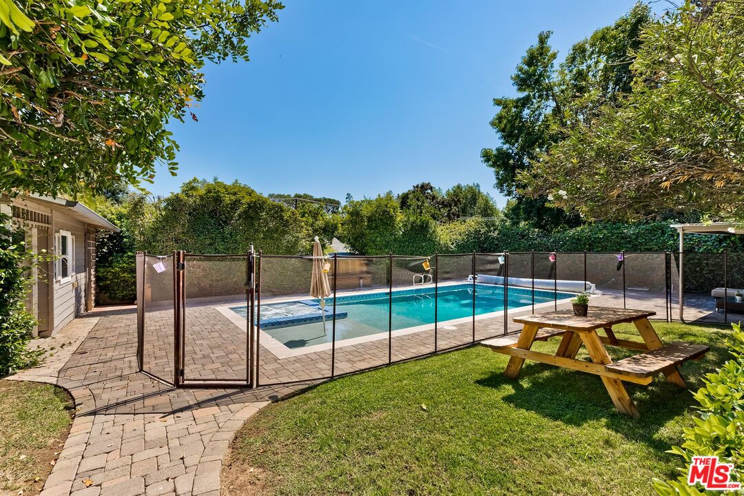 929 Mesa Verde Road Pasadena, CA 91105 - Photo 41 of 51 a backyard of a house with table and chairs