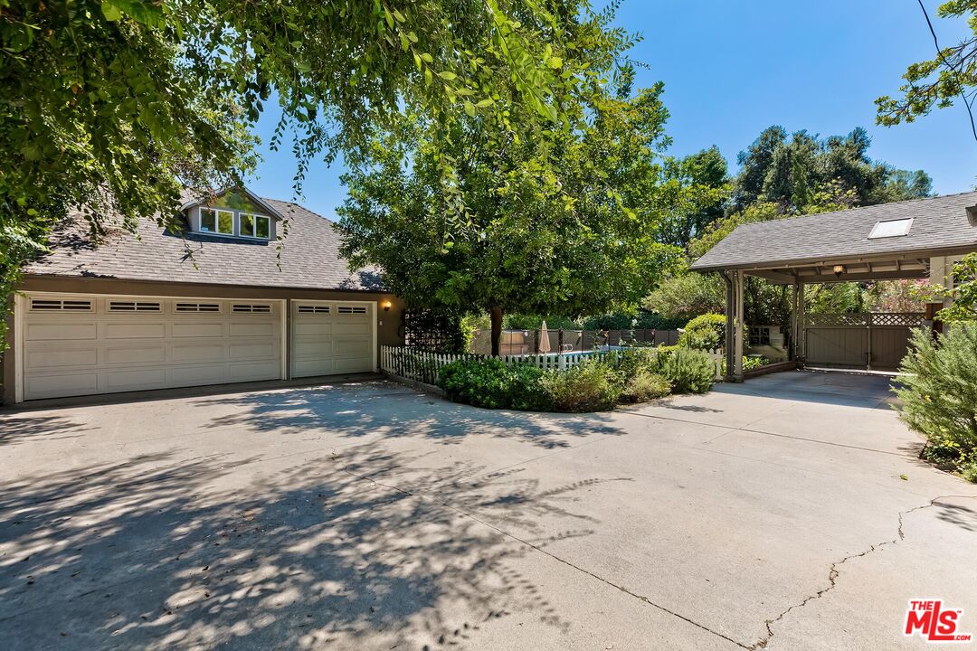 929 Mesa Verde Road Pasadena, CA 91105 - Photo 44 of 51 a front view of a house with a yard and a garage