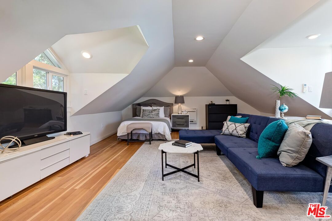 929 Mesa Verde Road Pasadena, CA 91105 - Photo 47 of 51 a living room with furniture and a flat screen tv