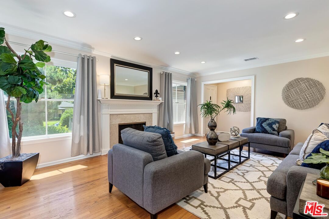 929 Mesa Verde Road Pasadena, CA 91105 - Photo 10 of 51 a living room with furniture a fireplace and a potted plant