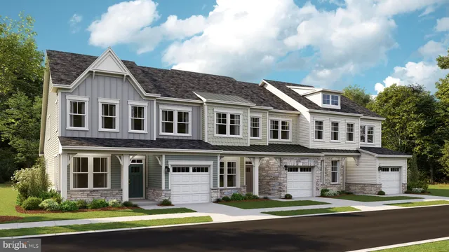 a front view of a house with a yard and lake view