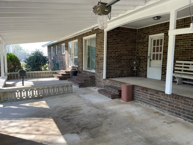 91 Sunny Acres Road Morrison, TN 37357 - Photo 4 of 34 a view of a patio with table and chairs and potted plants
