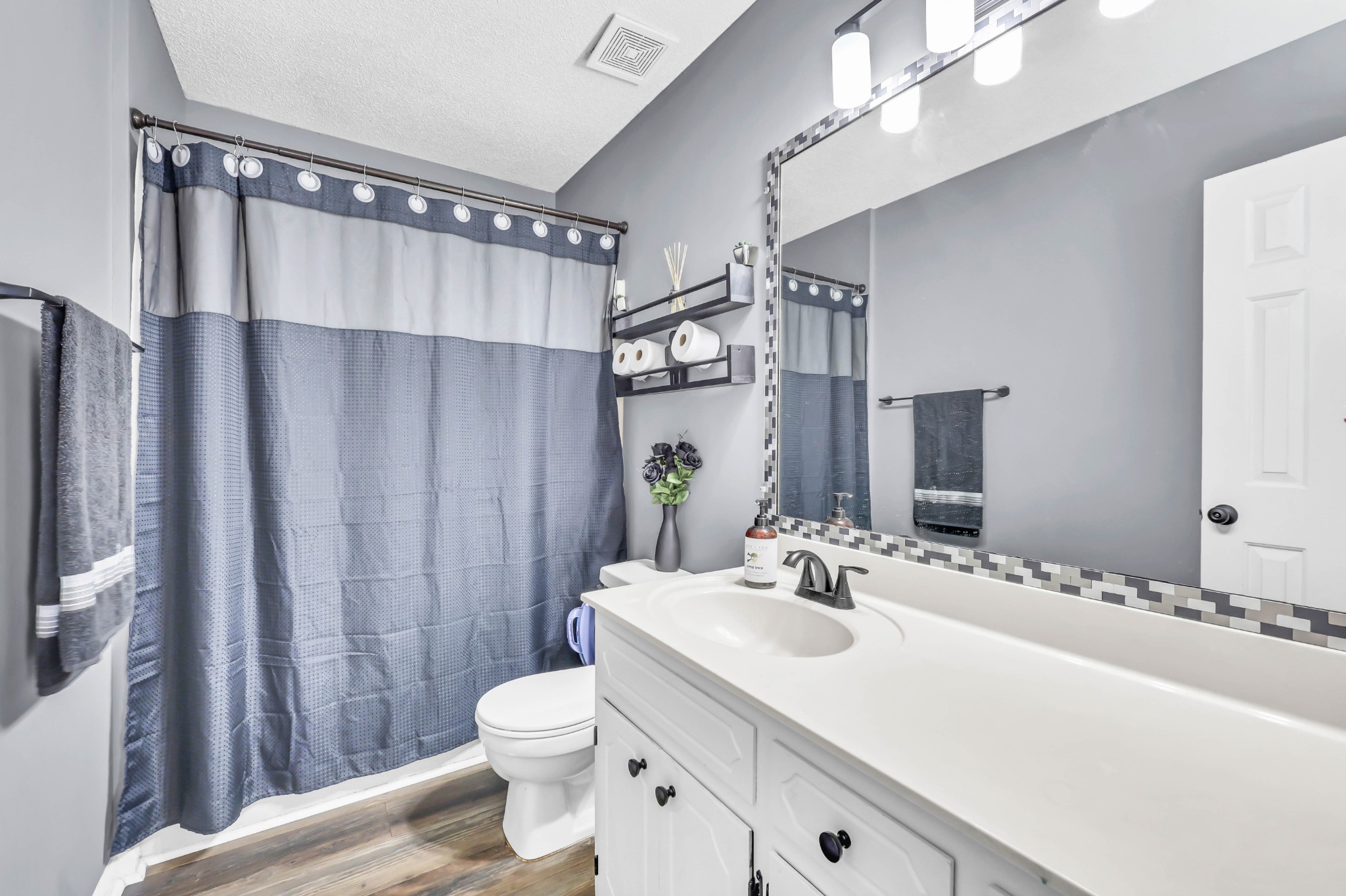1440 McClardy Road Clarksville, TN 37042 - Photo 21 of 33 a bathroom with a sink a toilet a mirror and shower curtain