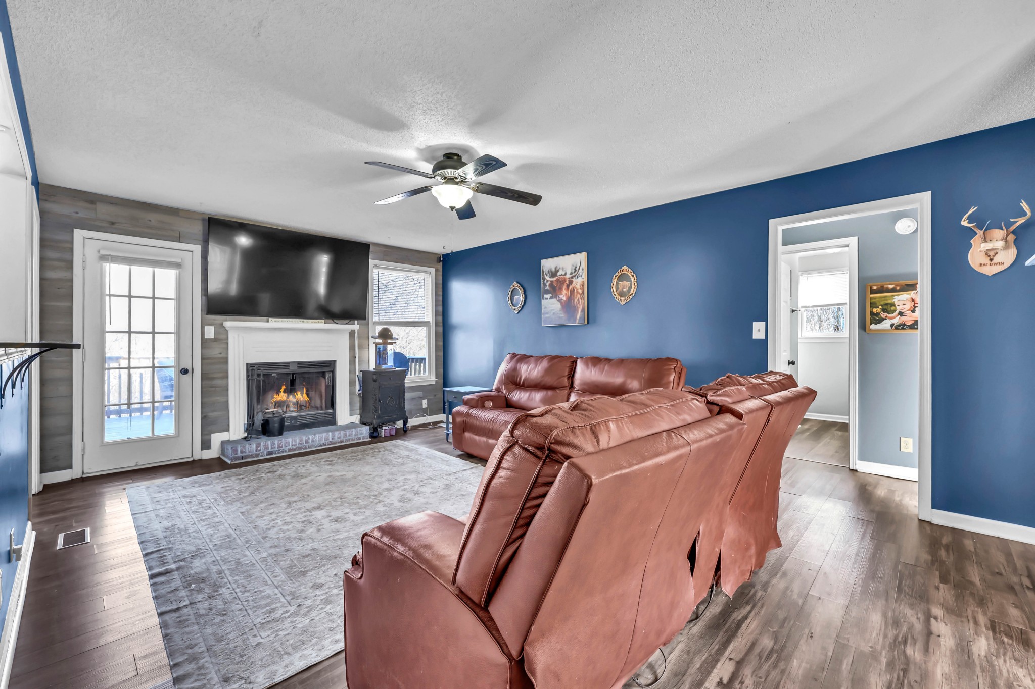 1440 McClardy Road Clarksville, TN 37042 - Photo 6 of 33 a living room with furniture a flat screen tv and a fireplace