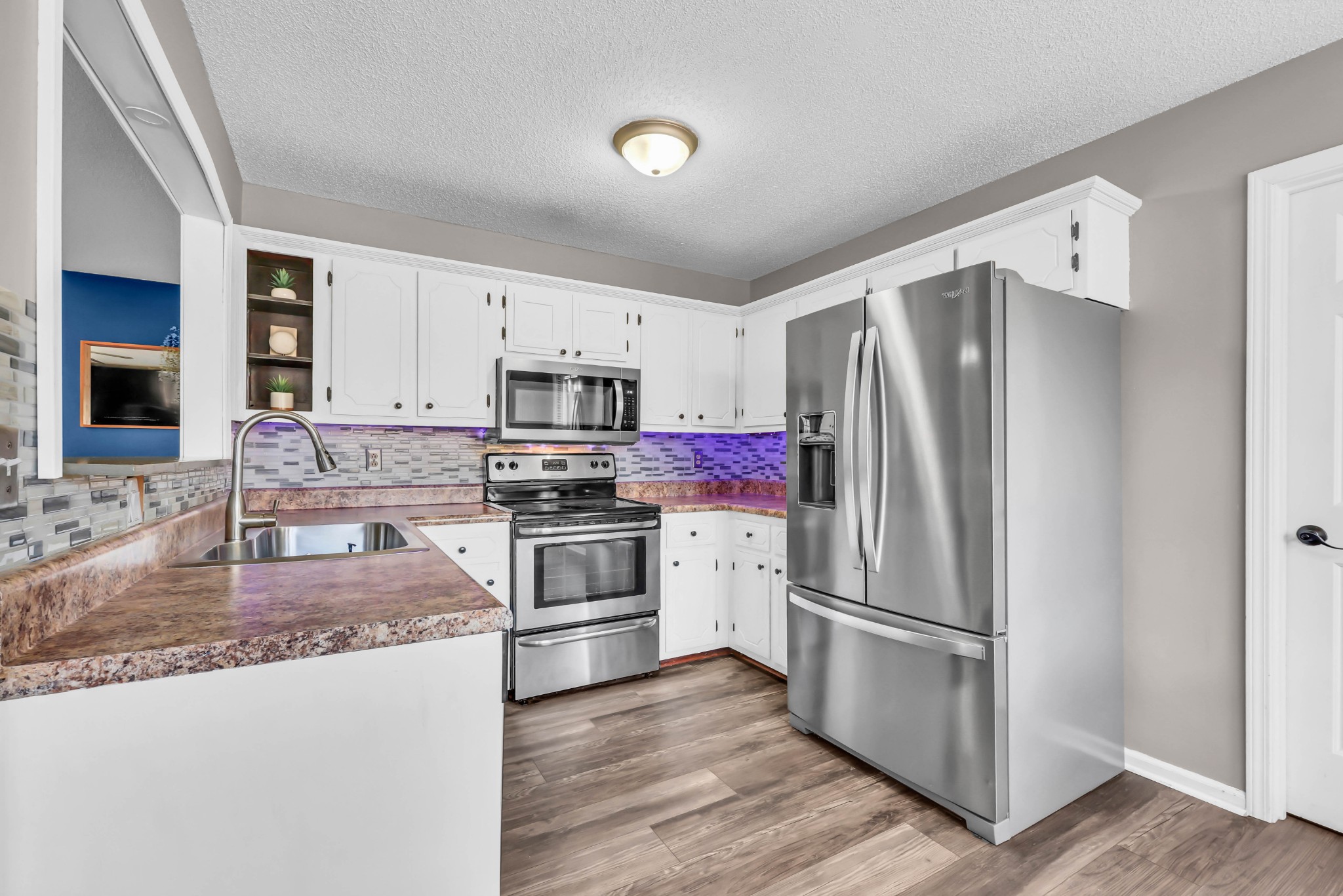 1440 McClardy Road Clarksville, TN 37042 - Photo 10 of 33 a kitchen with granite countertop a refrigerator stove and sink