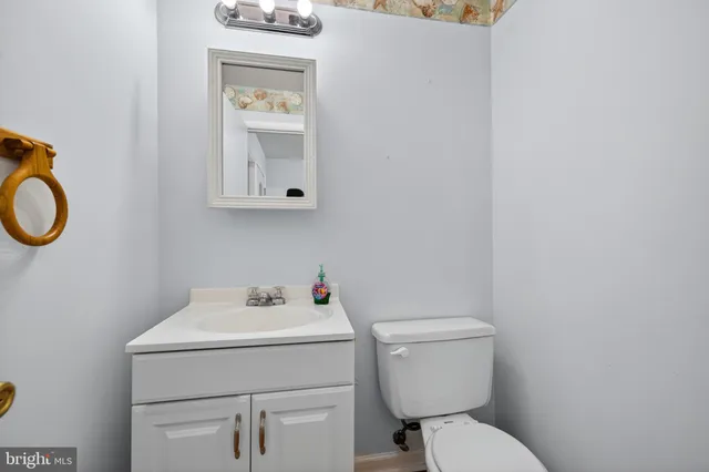 a bathroom with a toilet sink and mirror